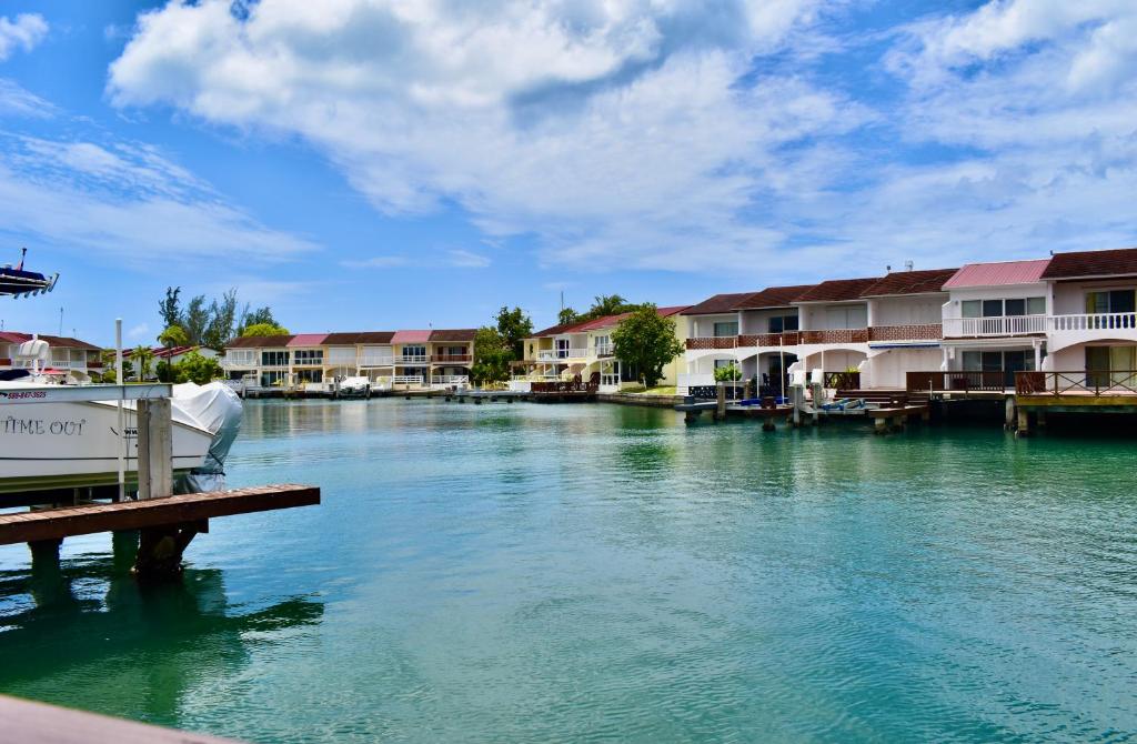Jolly HarbourにあるVilla 224 South Finger 2-Bedroom Villa in Jolly Harbour, Walking Distance to the Beachの家屋と桟橋のある川の景色