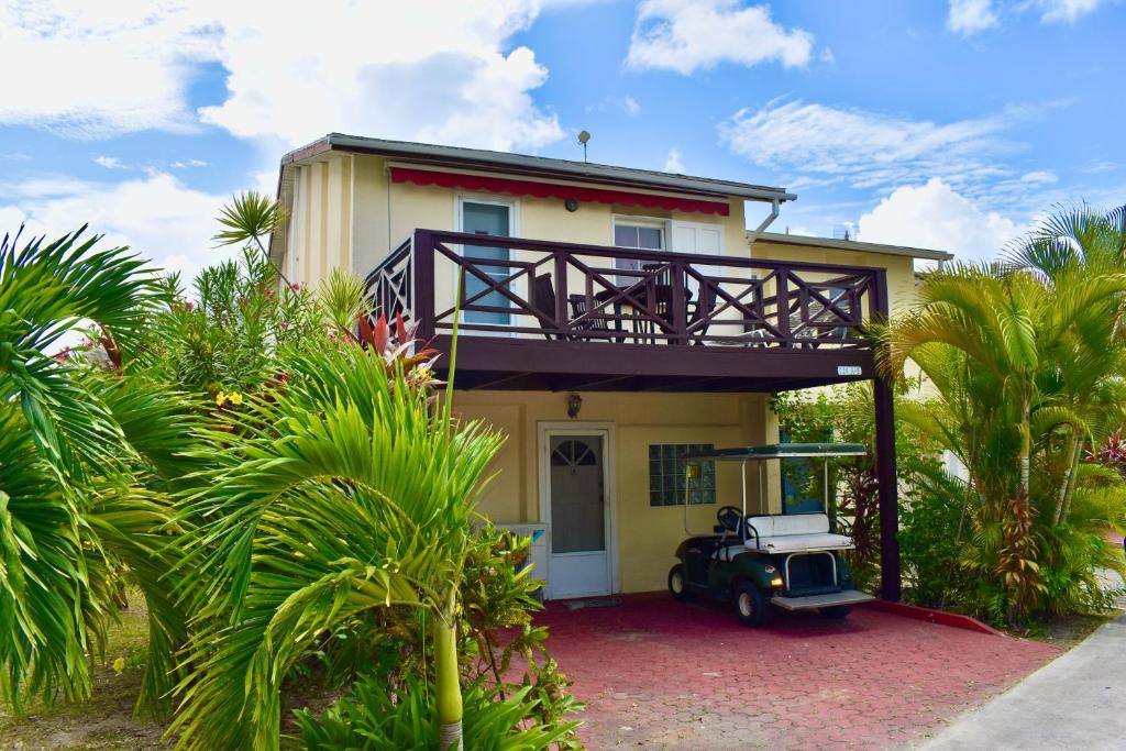 a house with a car parked in front of it at South Finger Villa in Jolly Harbour