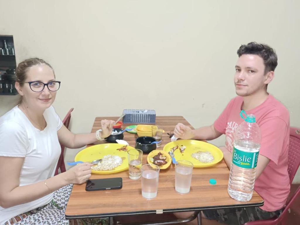 a man and a woman sitting at a table with food at SS RESIDENCY in Māranhalli