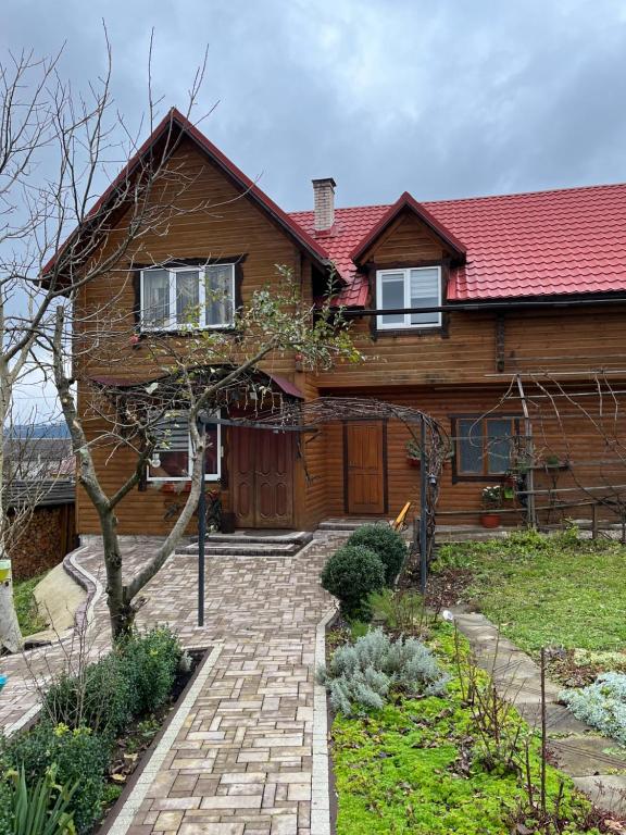 a house with a brick walkway in front of it at Марічка Marichka in Vorokhta