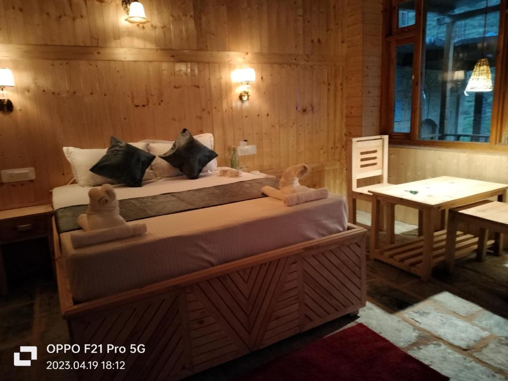 a bedroom with a bed with two stuffed animals on it at Obvallata lotus cottages in Bathād