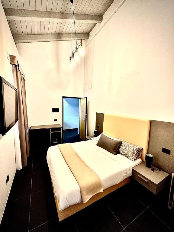 un dormitorio con una cama grande y un televisor en Dazio Exclusive Rooms, en Roma