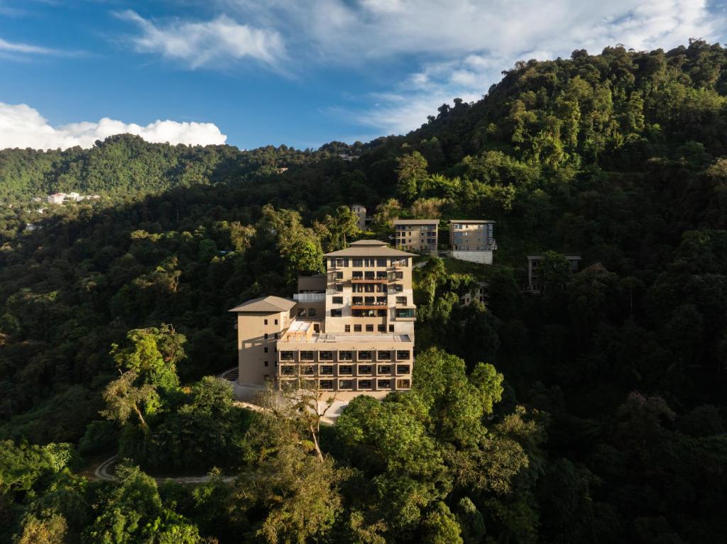 a building on the side of a mountain at Taj Guras Kutir Resort & Spa, Gangtok in Gangtok