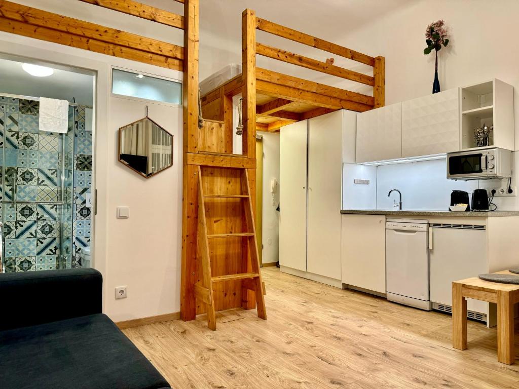 a loft apartment with a kitchen and a ladder at Urban by BestChoice - FREE Parking - Self Check-in in Graz