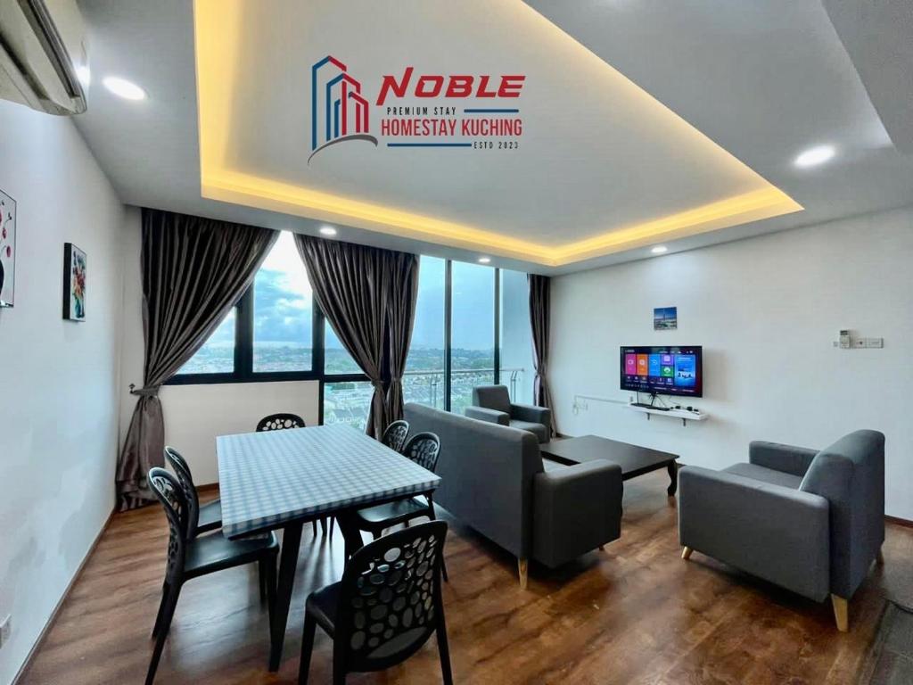 a waiting room with a table and chairs and a television at Noble Vivacity Jazz 2 Cozy Homestay in Kuching