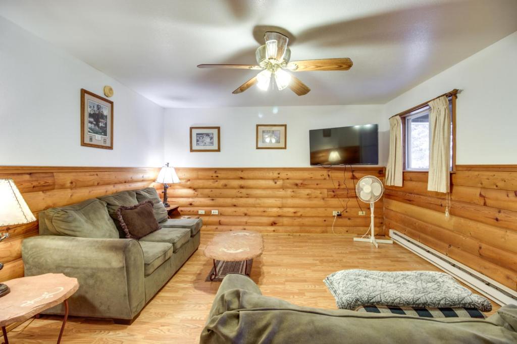 a living room with a couch and a ceiling fan at Lakefront Bemidji Getaway with Community Beach! in Bemidji