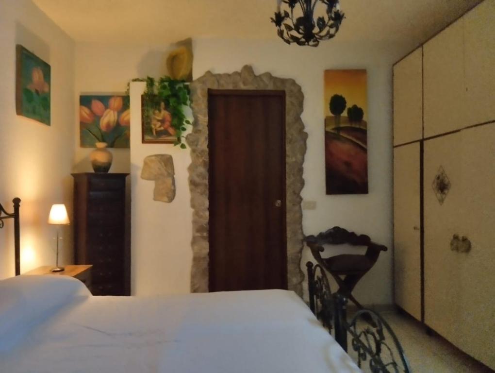 Schlafzimmer mit einem Bett und einer Holztür in der Unterkunft CASA VACANZE PIEKNY DOM DWA in Taormina