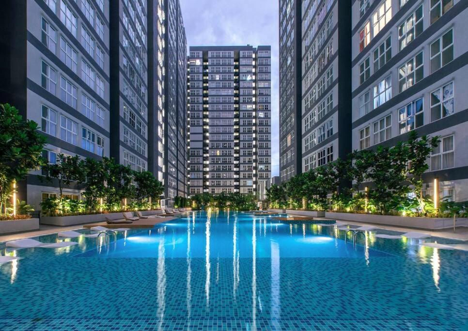a large swimming pool in a city with tall buildings at The Maisonnette Homestay in Kajang