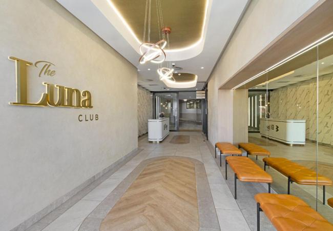 a waiting room with benches and a sign on the wall at Executive Suite at Ellipse in Waterfall Midrand in Midrand