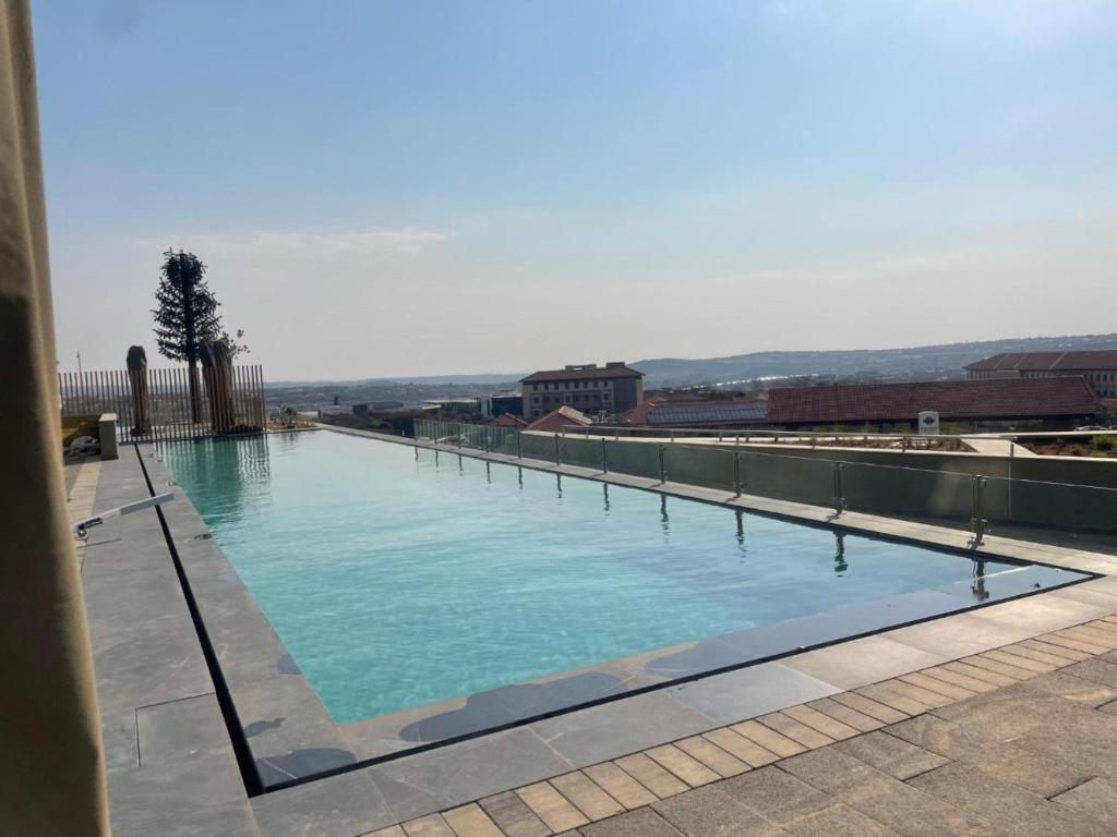a large swimming pool on top of a building at Executive Suite at Ellipse in Waterfall Midrand in Midrand