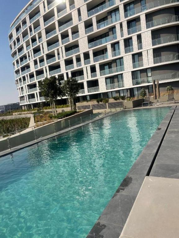 a swimming pool in front of a large building at Executive Suite at Ellipse in Waterfall Midrand in Midrand