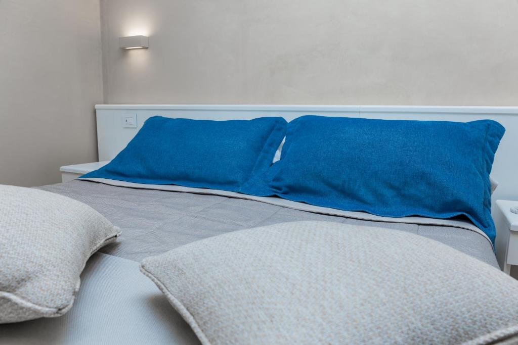 a bed with two blue pillows on top of it at EUROPA Hotel in Vasto