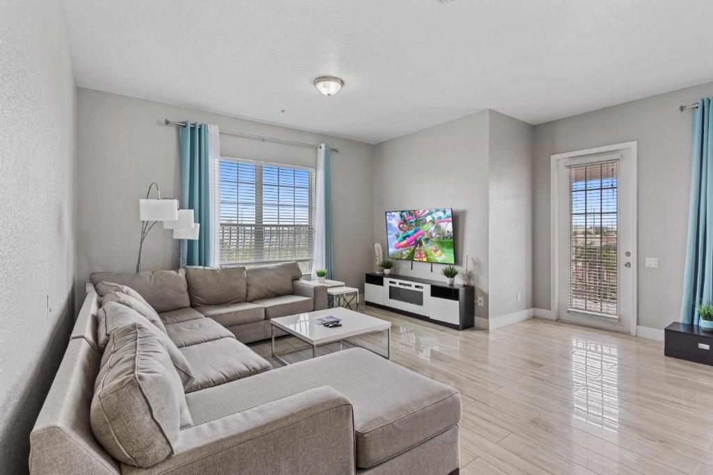 a living room with a couch and a tv at 5048 Shoreway Loop 407 in Orlando