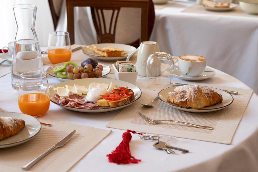 a table with plates of breakfast food on it at Palazzo Zacà in Gallipoli