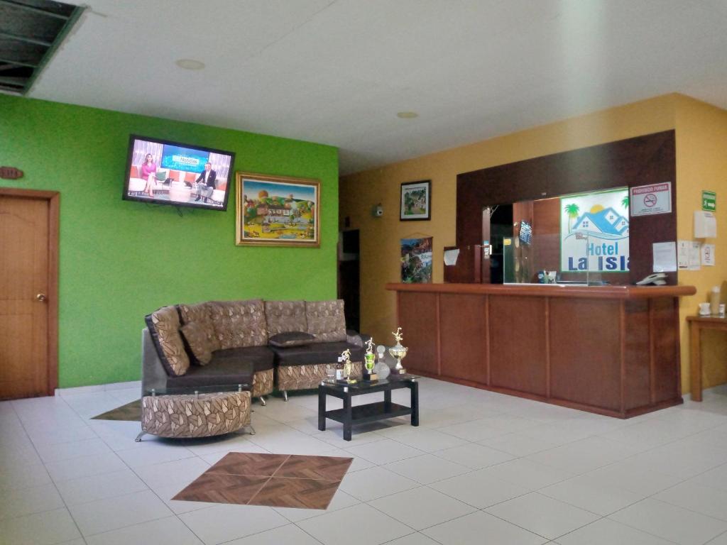 a waiting room with a couch and a cashier at Hotel La Isla in San Gil