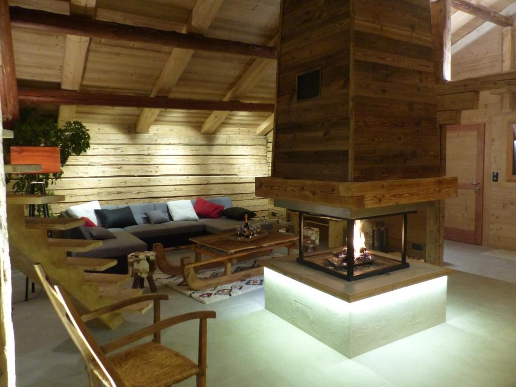 a living room with a fireplace and a couch at Appartement Le Grand-Bornand, 4 pièces, 10 personnes - FR-1-467-100 in Le Grand-Bornand