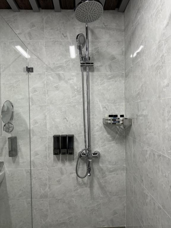 a shower with a glass door in a bathroom at Mir Luxe Plaza in Tashkent