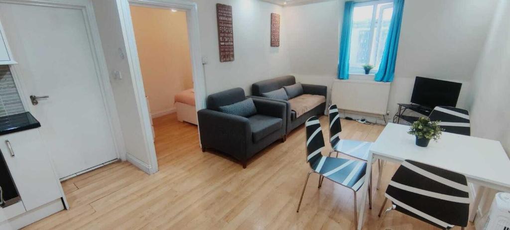 a living room with a couch and a table and chairs at Kings Central Apartments in Kings Cross in London