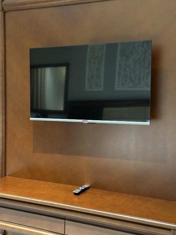 a remote control sitting on a counter with a television at Mir Luxe Plaza in Tashkent
