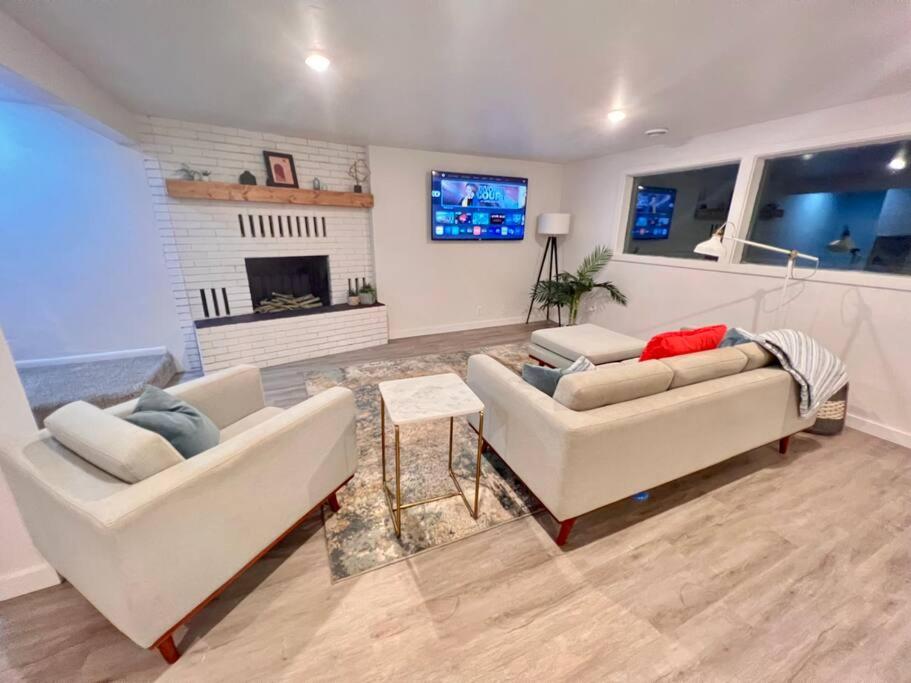 a living room with two couches and a fireplace at Mid Century Modern Montana Dream Home in Butte