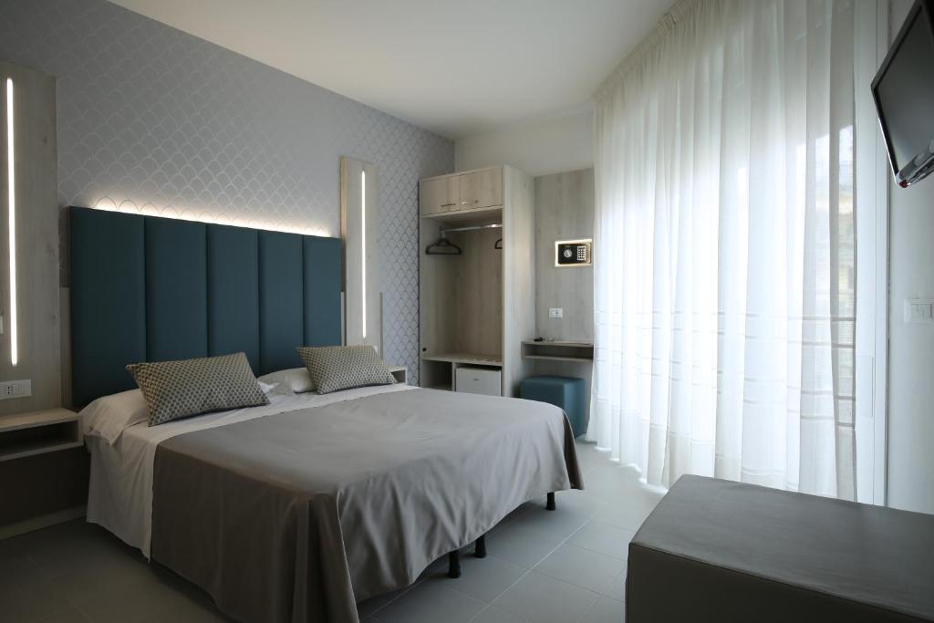 Postel nebo postele na pokoji v ubytování Hotel Marisa