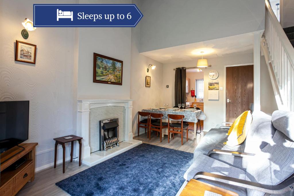 a living room with a couch and a fireplace at Spacious House in Sheffield - Great Location! in Attercliffe