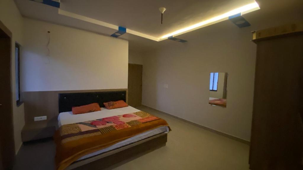 a bedroom with a bed in a room at Paradise residency and cafe in Gwalior