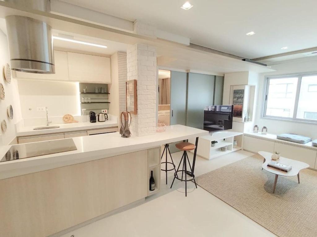 a kitchen with white counters and a counter top at Saint Paul Apartment by BnbHost in Sao Paulo