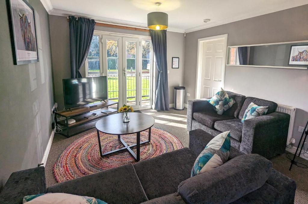 a living room with two couches and a table at Superb Modern Apartment, FREE Secure Parking! in Allesley