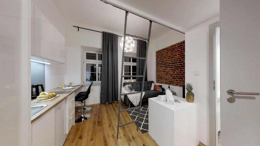 a room with a kitchen and a living room at APARTHOTEL TECTUM in Wrocław