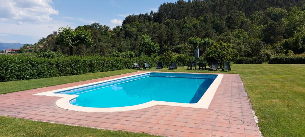 a swimming pool in the middle of a yard at Casa Quinta das Vessadas in Celorico de Basto