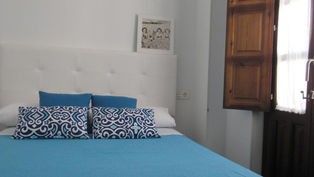 Posteľ alebo postele v izbe v ubytovaní Apartamentos Ilíberis
