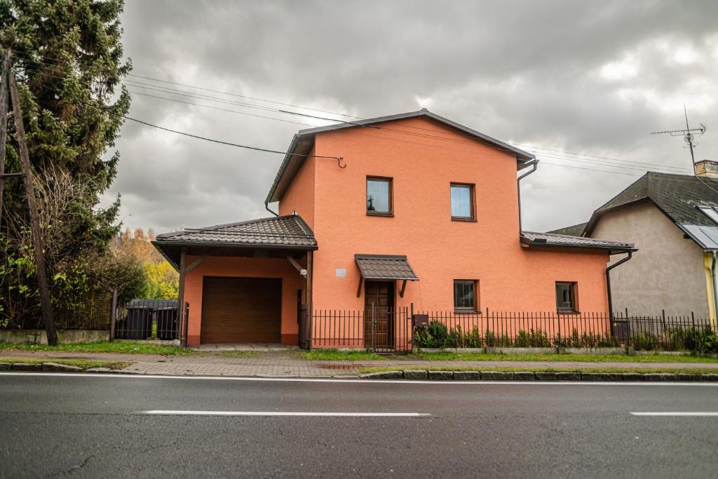 a orange house on the side of a street at Vilka Viktorka in Velké Losiny