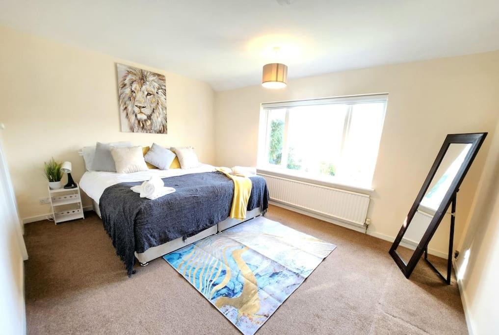 a bedroom with a large bed and a window at Lovely Spacious Stays in Cambridge