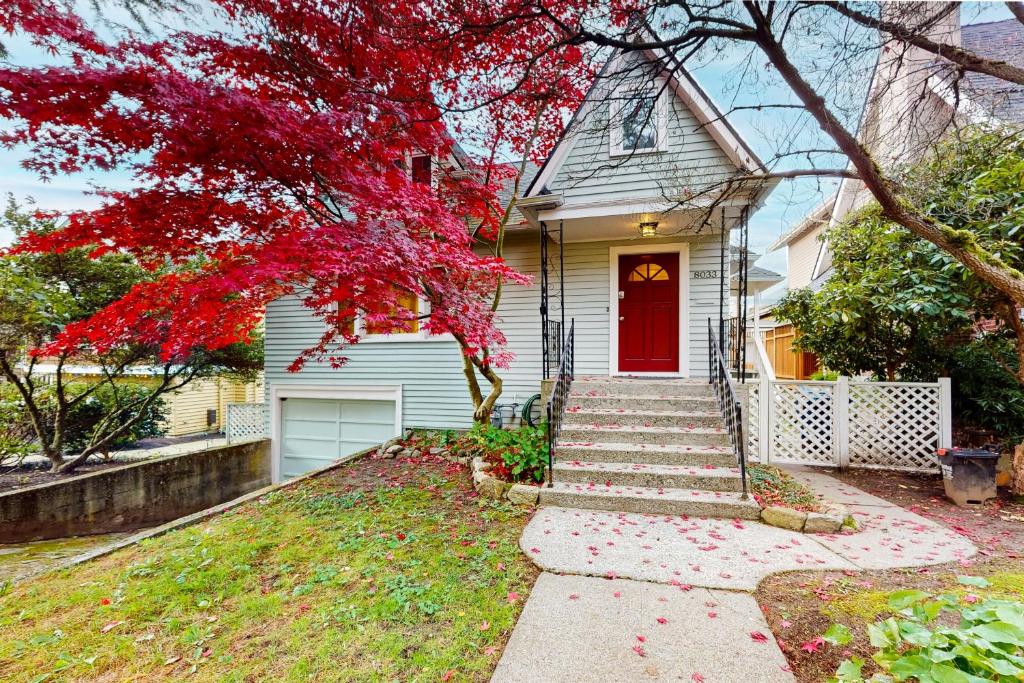 a white house with a red door and stairs at Sunnyside Up in Seattle