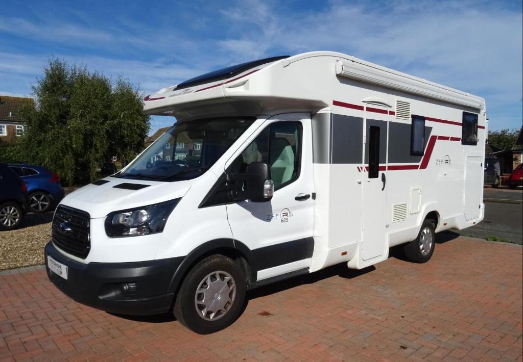 a white rv parked in a parking lot at RollerTeam Zafiro 685 - 5 Berth Motorhome in Kirton