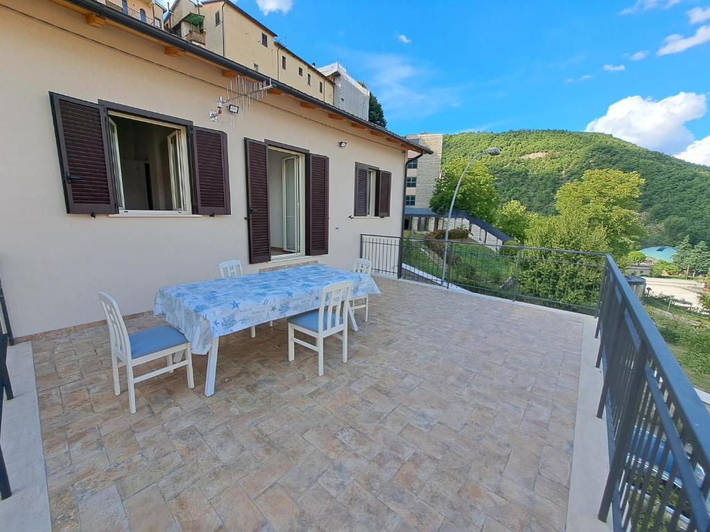 a table and chairs on the patio of a house at Dolce Dimora in Cascia