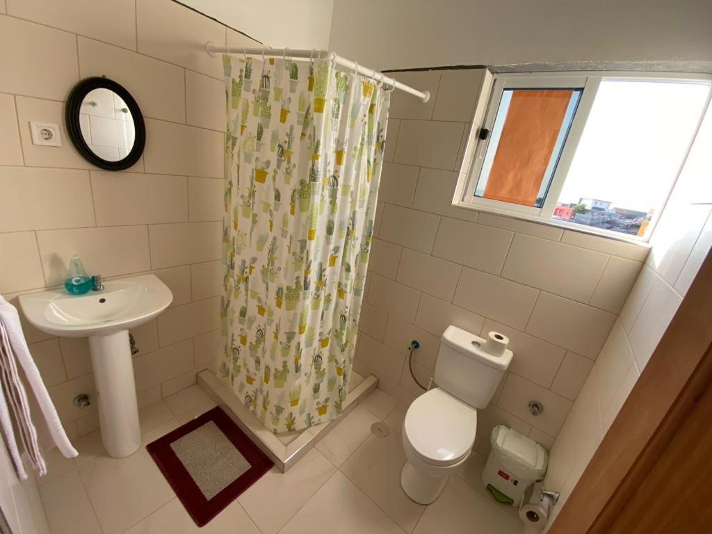 a small bathroom with a toilet and a sink at Pousada Cantinho de Preta in Seladinha
