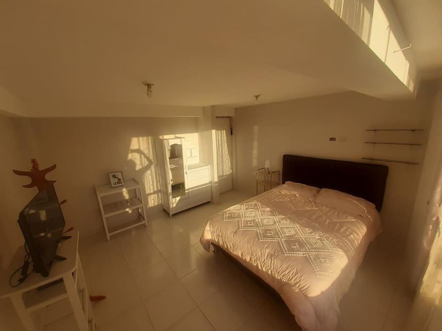 a bedroom with a bed and a tv in it at Apartamento en Cusco in Cusco