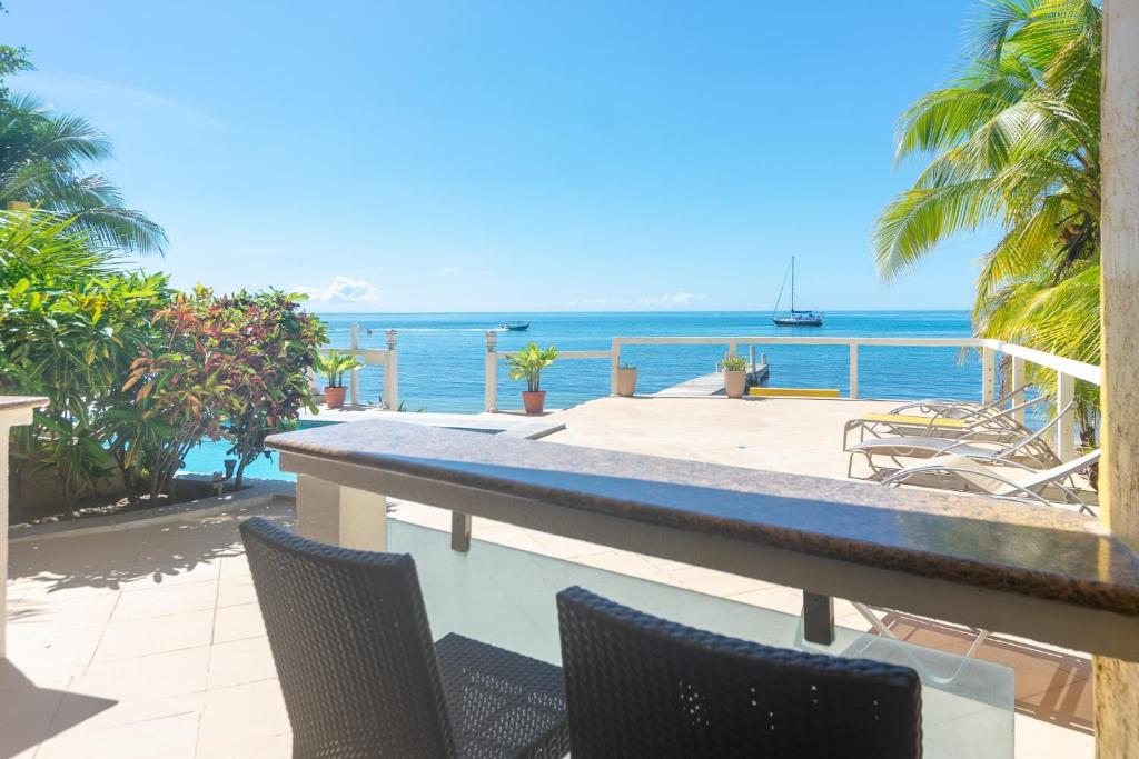 a view of the ocean from the balcony of a house at Del Playa #2 Condo in West End