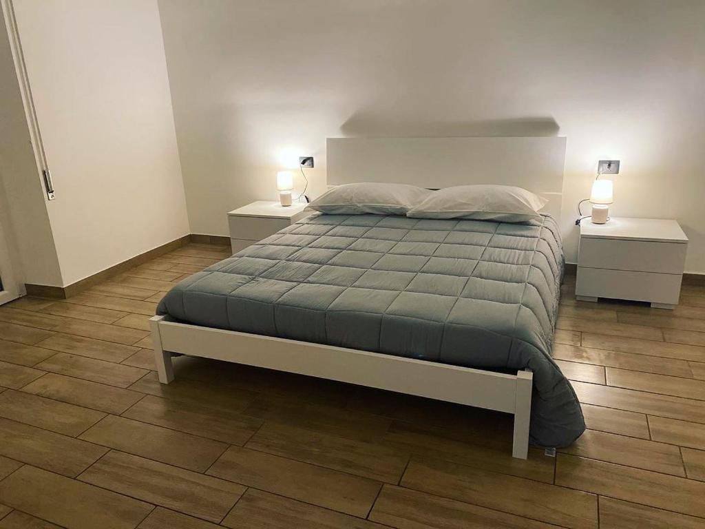 a bedroom with a large bed with two night stands at Residenza Mazzini in Avezzano