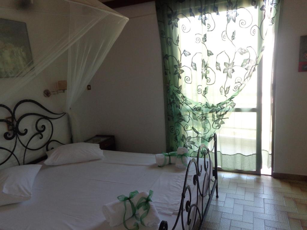 Postel nebo postele na pokoji v ubytování Angela Hotel