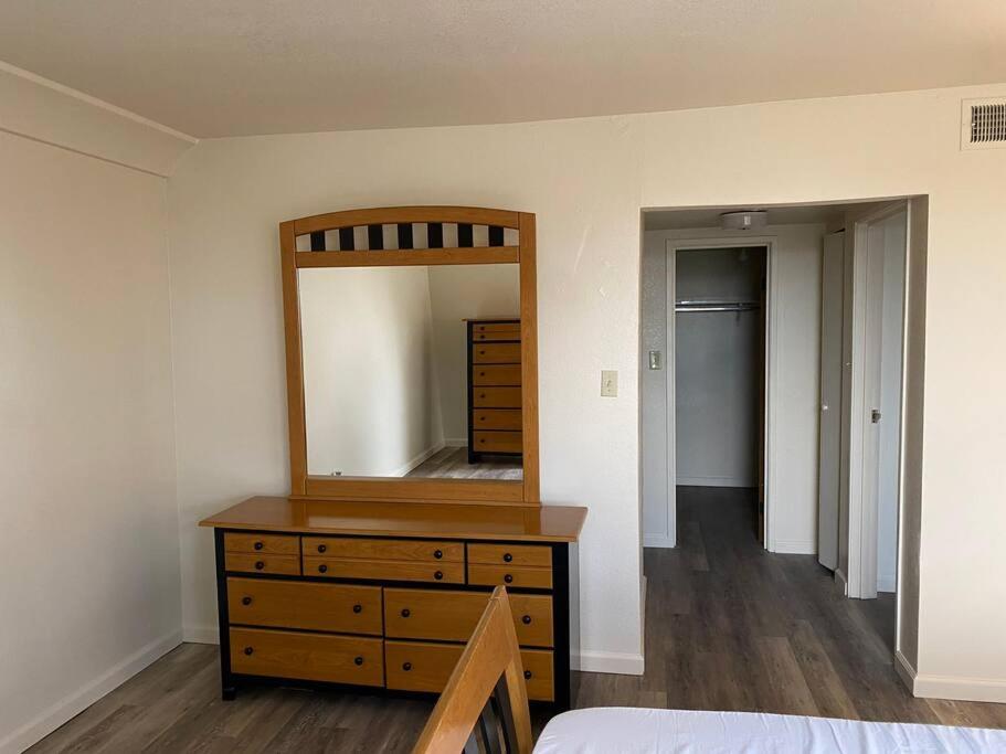 a bedroom with a dresser with a mirror on it at One Bedroom Executive Condo Close to UNR and TMCC in Reno