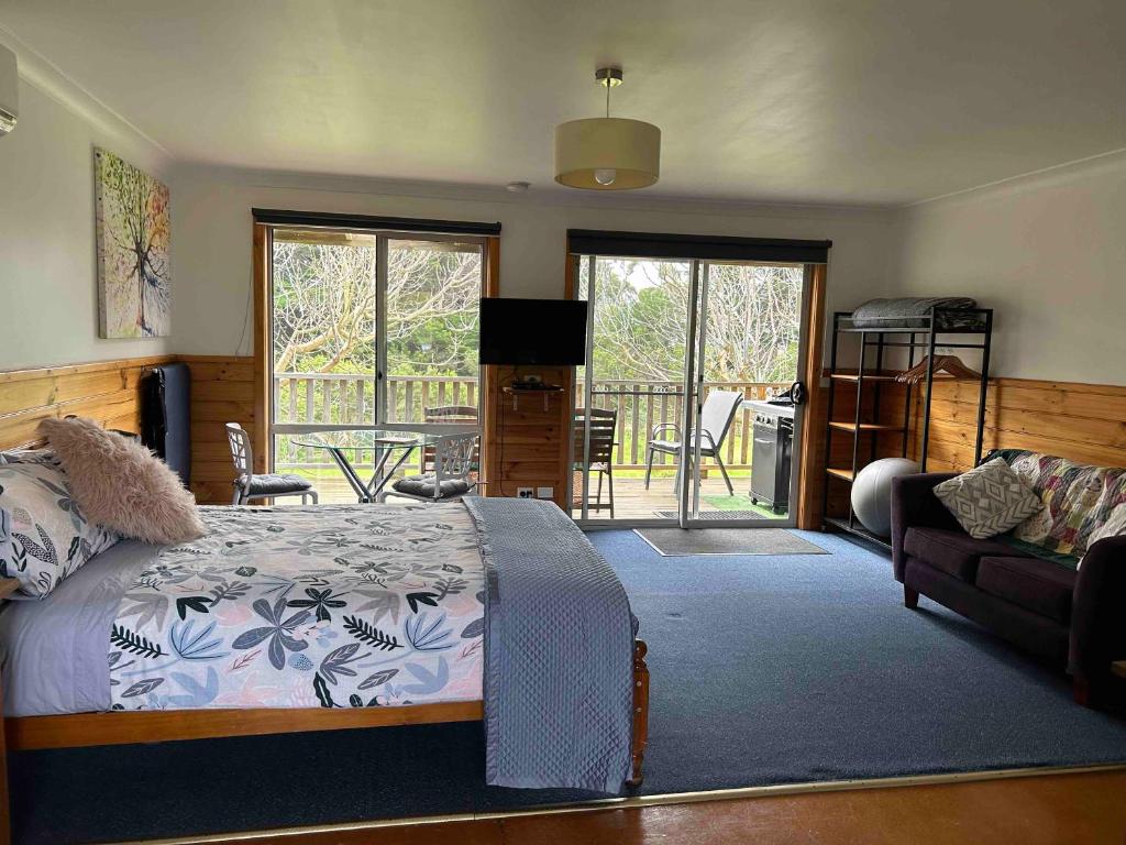 a bedroom with a bed and a living room at Vayu Vista in Princetown