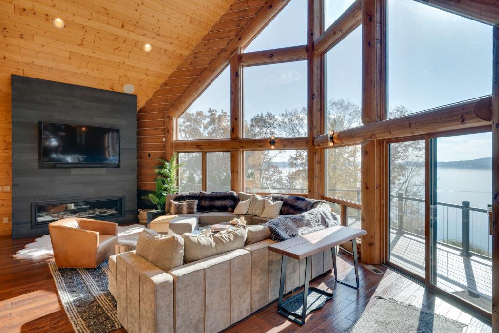 a living room with a couch and a fireplace at Lake Wisconsin Lodge with Dock and Pool Near Skiing! in Merrimac