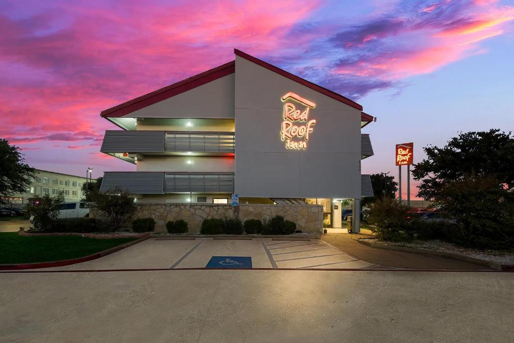 un edificio con un cartel en el costado en Red Roof Inn Dallas - DFW Airport North en Irving