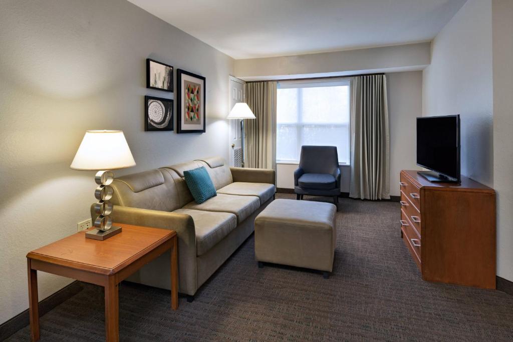 a living room with a couch and a tv at Residence Inn Shreveport Airport in Shreveport