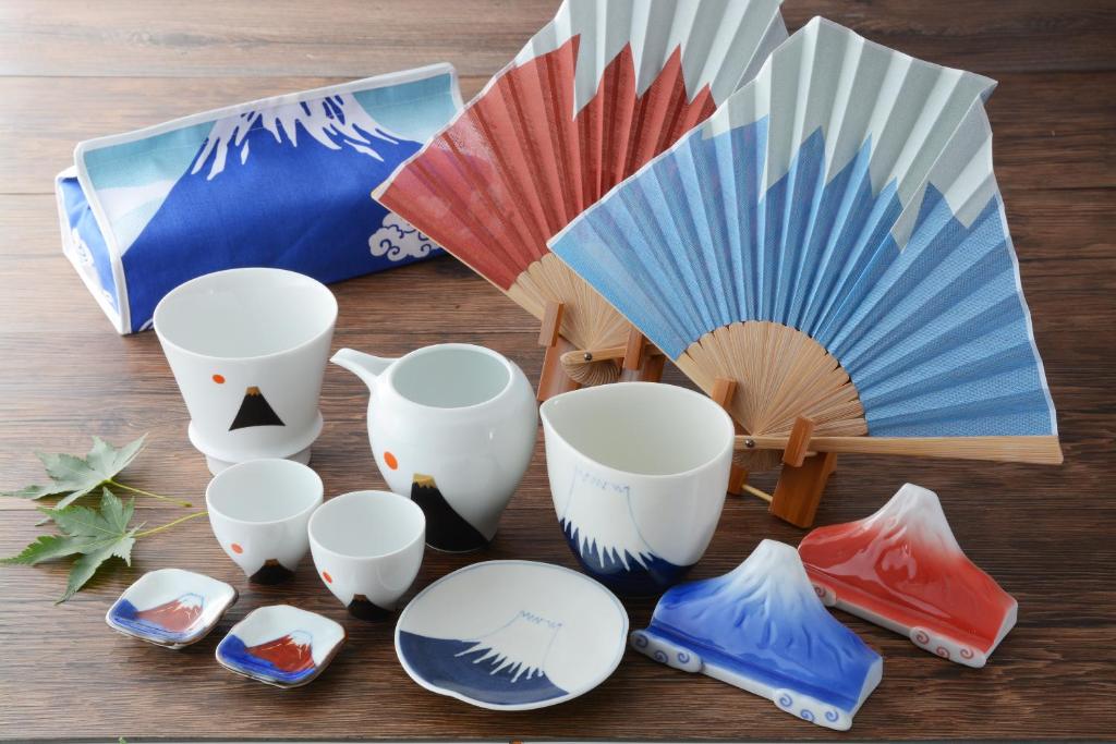 a group of cups and plates and an umbrella at Hotel Binario Saga Arashiyama in Kyoto