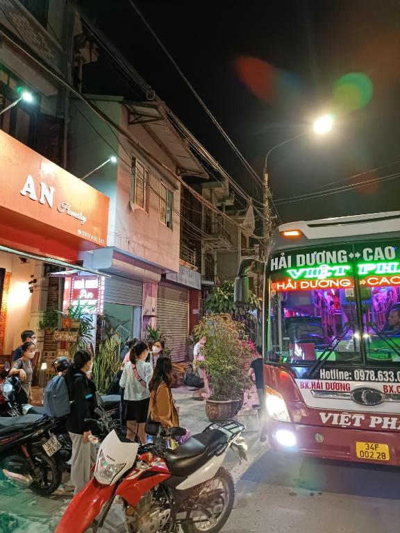 a bus driving down a city street at night at An Homestay & Hostel Motorbikes & Tours in Cao Bằng