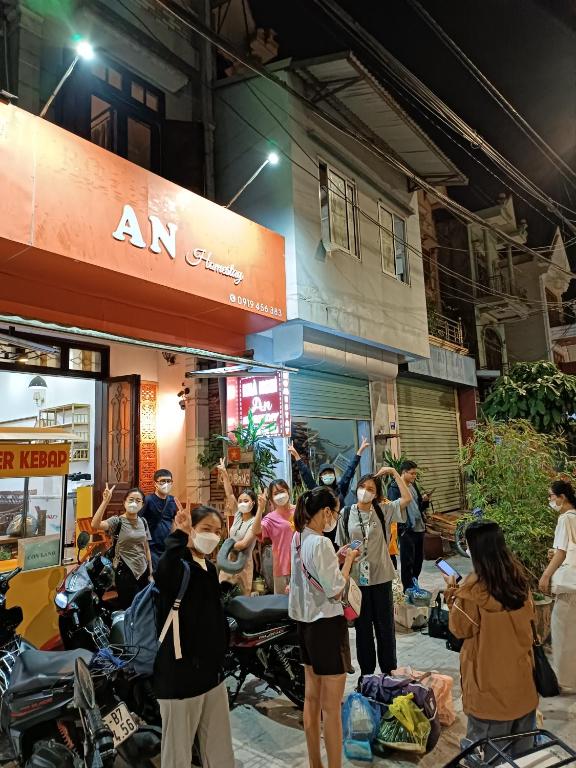 a group of people wearing face masks outside a store at An Homestay & Hostel Motorbikes & Tours in Cao Bằng